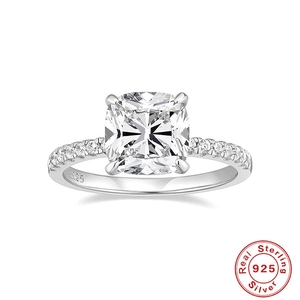 Detail of cushion-cut diamond ring with S925 sterling silver hallmark and pavé band