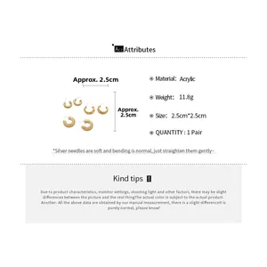 Detailed view of acrylic textured C-shaped gold earrings with silver needle specs