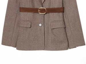 Detailed shot of brown herringbone wool blazer with a matte leather belt and golden buckle