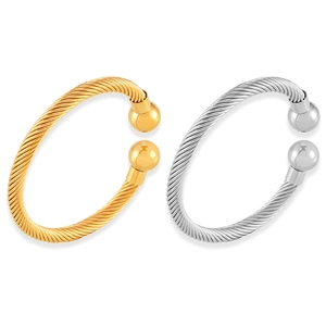 Twisted cable titanium steel bangles in gold and silver with ball ends on white background