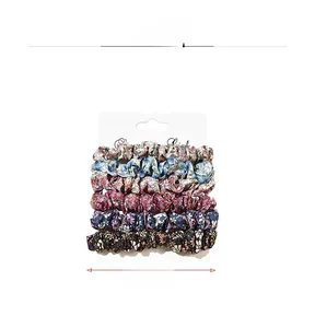 Detail view of 6-piece floral scrunchie set with 8cm diameter and cardboard packaging