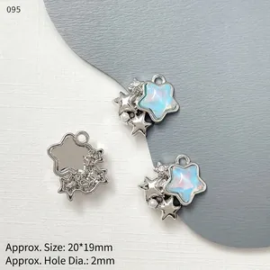 Macro detail of star-shaped jewelry charms with aurora blue center and faux pearl