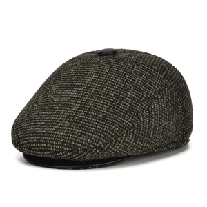 Close-up of winter warm peaked cap showing dark brown tweed texture and velvet lining