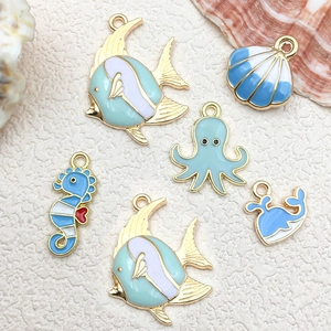 Flat lay of blue ocean animal charms including starfish and octopus for DIY jewelry