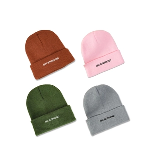 Knit beanie set with NOT INTERESTED embroidery in brown, pink, green, and grey colors