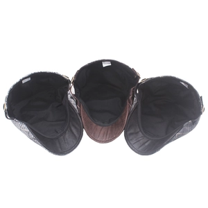 Detailed interior view of plaid newsboy caps with diverse patterns and leather brims