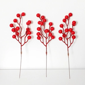 Three vibrant red artificial berry branches for Christmas tree and floral decoration