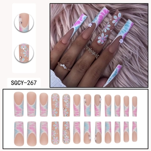 Long coffin press-on nails with blue tie-dye floral patterns and 3D flower accents