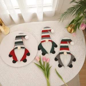 Three Christmas gnome cutlery holders in red green and grey for festive table decor