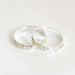 Minimalist S925 sterling silver ring featuring a vibrant yellow gemstone on white background