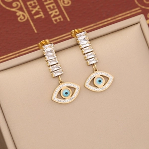 Golden evil eye earrings with turquoise and rectangle zircon displayed in a beige box