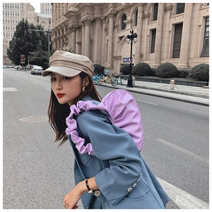 Chic purple pleated cloud bag and beige PU baker boy hat styled on urban street
