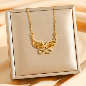 Luxurious gold-plated infinity wing necklace with pavé cubic zirconia on satin background