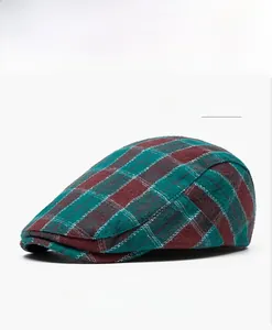 Detail view of the green and red plaid pattern on a vintage cotton duckbill cap