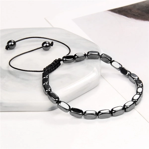 Adjustable black hematite bead bracelet with vintage woven rope on marble tray