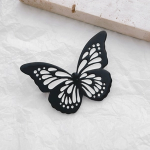 Luminous butterfly couple brooch with elegant black and white enamel wings on stone
