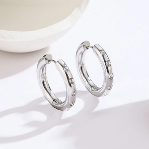 Minimalist silver hoop earrings with sparkling inlaid crystals for a stylish daily look