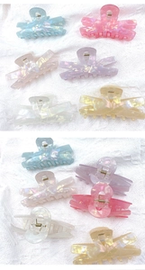 Detail shot of multi-colored laser acrylic hair claws in blue, pink, and purple colors