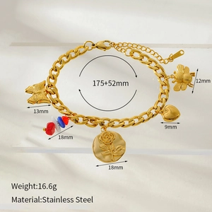 Macro detail of 18K gold plated stainless steel bracelet with flower and bee charms