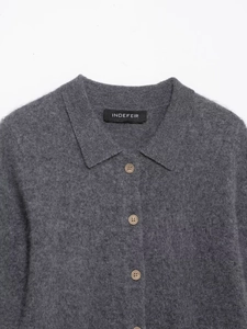 Close-up of gray knit cardigan featuring a polo collar and textured wood buttons