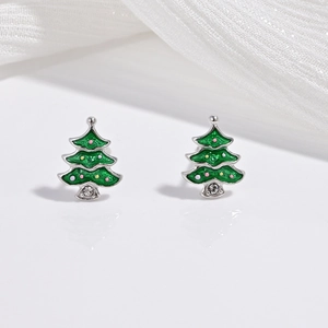 Close-up of S925 silver Christmas tree earrings with green enamel and sparkling crystals