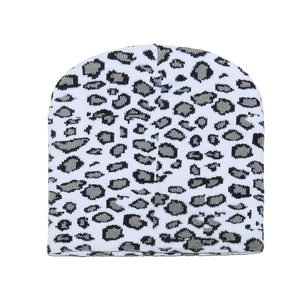 Macro detail of leopard pattern knit texture on white and grey speckled beanie hat