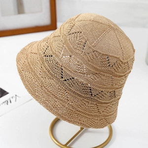 Detailed close-up of breathable woven pattern on a beige sun hat with chic bow accent
