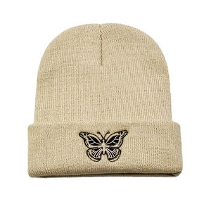 Beige knitted beanie hat featuring a colorful butterfly embroidery for winter warmth