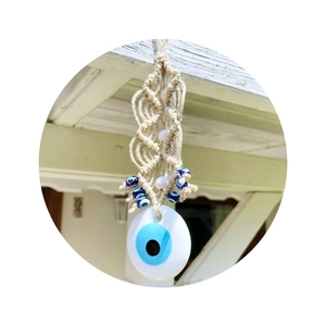 Handcrafted macrame Evil Eye wall hanging with blue beads and large glass eye pendant