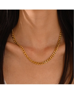 Close-up of a gold-plated Cuban link necklace on a model's neck for a chic look