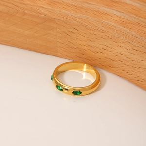 Macro view of gold vintage geometric ring with three marquise-cut emerald stones