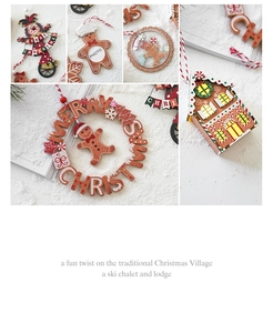 Detailed view of wooden Christmas house ornaments with photo frames and gingerbread motifs