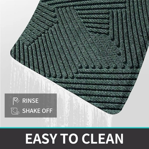 Close-up of green PVC coil mat showing easy rinse cleaning with water flow detail