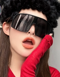 Close-up of oversized square cycling sunglasses with black frame on a model