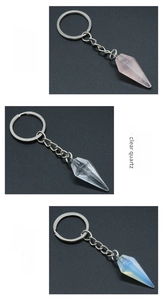 Detailed display of conical crystal keychains in rose quartz, clear quartz and opal stones