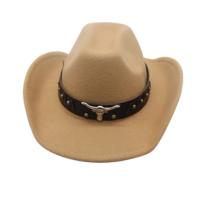 Detail of the brown felt cowboy hat featuring a leather band and silver bull head metal piece