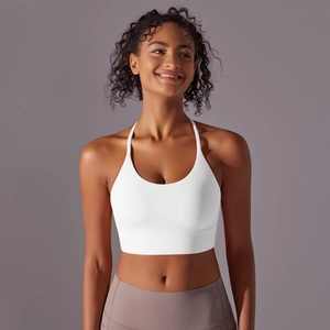 Close-up of white high-elastic yoga bra with thin straps and wide support band
