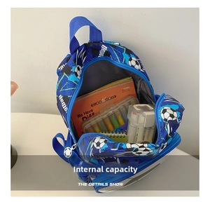 Detailed view of the blue kids football backpack interior filled with school supplies