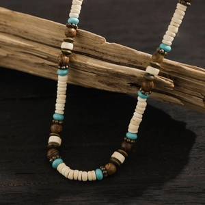 Detailed shot of Bohemian beaded necklace with turquoise and coconut wood beads