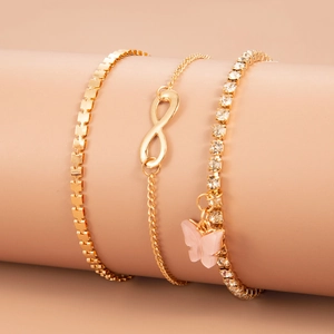 Gold layered bracelet set featuring pink butterfly charm and infinity symbol