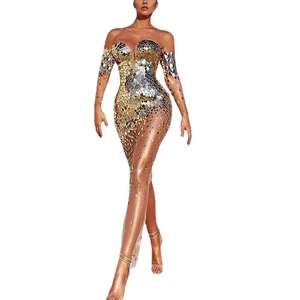 Detail of sequin evening gown showing sheer mesh V-neckline and shimmering gold silver scales