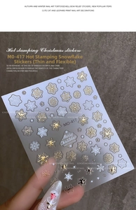 Makrodetail der MO-417 Bronzing-Schneeflocken-Nagelaufkleber mit gold-weißen Sternmustern