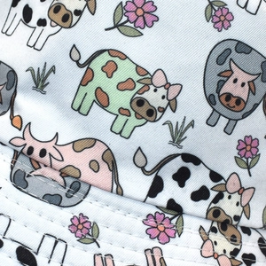 Close-up of colorful cow print and floral patterns on cotton fisherman bucket hat