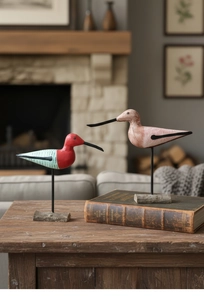 Detail of Nordic hand-painted wooden bird figurines on metal stands and wooden bases