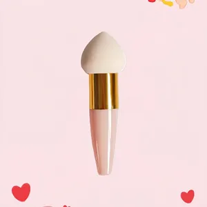 Detail of mushroom sponge makeup brush with white drop head and pink handle