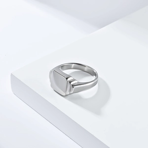 Macro view of polished silver square signet ring with geometric industrial design