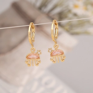 Detail of golden jellyfish earrings featuring pink faceted stones and clear zircon accents