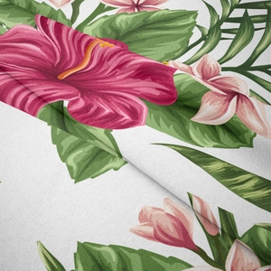 Close-up of bohemian tapestry fabric featuring pink hibiscus flowers and tropical green leaves