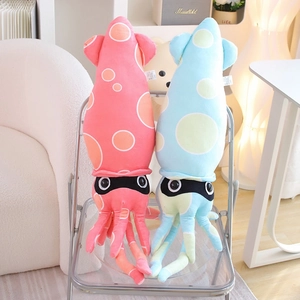 Plush squid stuffed animals in pink and blue colors on a chair for home decor
