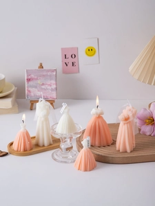 Creative wedding dress scented candles in pink and white on a decorative wooden tray